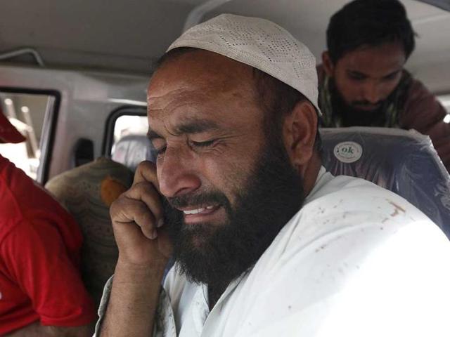 A relative mourns the death of a student, who was killed in an explosion, in an ambulance outside a hospital morgue in Karachi. (Reuters)