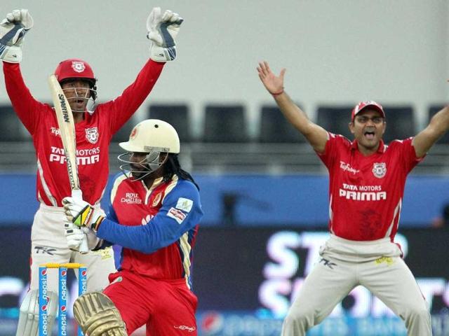 Kings X1 Punjab's Wriddhiman Saha and Virender Sehwag appeal for LBW of Royal Challengers Bangalore batsman Chris Gayle during a T20 match for Indian Premier League 2014 at the Dubai International Stadium, Dubai, United Arab Emirates on Monday. (PTI Photo)