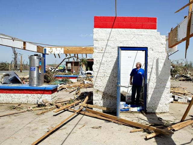 Ken Sullivan, general manager of We Willies Super Auto Wash, looks over the damage after a tornado yesterday tore through Arkansas for the second time in three years. (AFP Photo)