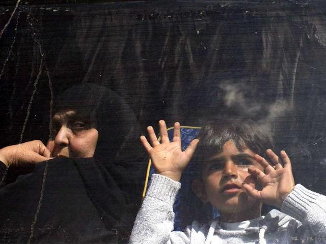 Palestinians hoping to cross into Egypt look out a bus window as they wait at the Rafah crossing between Egypt and the southern Gaza Strip. (Reuters Photo)