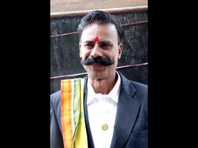 In-this-photograph-taken-on-September-11-2013-shop-owner-K-Padmarajan-poses-during-campaigning-in-Vadodra-in-the-western-state-of-Gujarat-AFP-photo-K-Padmarajan In-this-photograph-taken-on-September-11-2013-shop-owner-K-Padmarajan-poses-during-campaigning-in-Vadodra-in-the-western-state-of-Gujarat-AFP-photo-K-Padmarajan