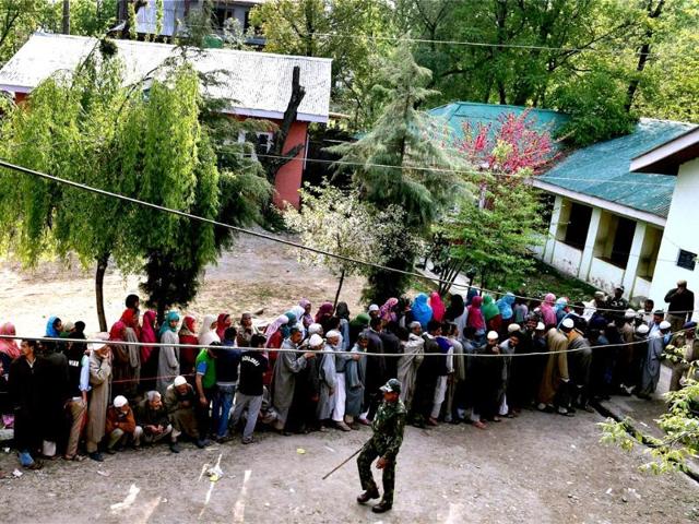 People wait to cast their vote for Srinagar Lok Sabha contituency at a polling station in Ganderbal district. (PTI photo)