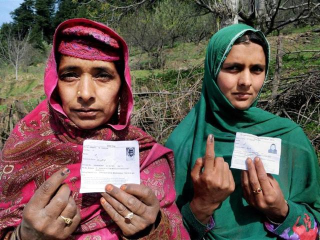 Women show their inked fingers after casting votes for LS polls in Ganderbal. (PTI photo)