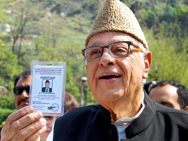 Union minister and National Conference candidate Farooq Abdullah shows his voter identity card before casting his vote for Lok Sabha elections, at a polling station in Srinagar. (PTI photo)