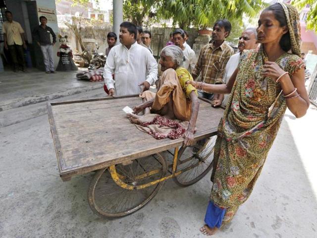 A woman sits on a handcart as she is being taken to a polling station to cast her vote during the seventh phase of Lok Sabha elections in Ahmedabad. (Reuters photo)