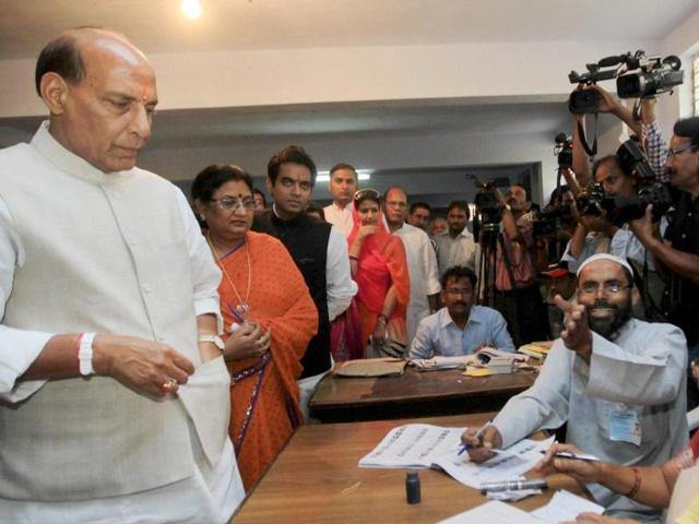 BJP president and candidate Rajnath Singh waits to cast his vote for Lok Sabha polls at a polling station in Lucknow. (PTI photo)