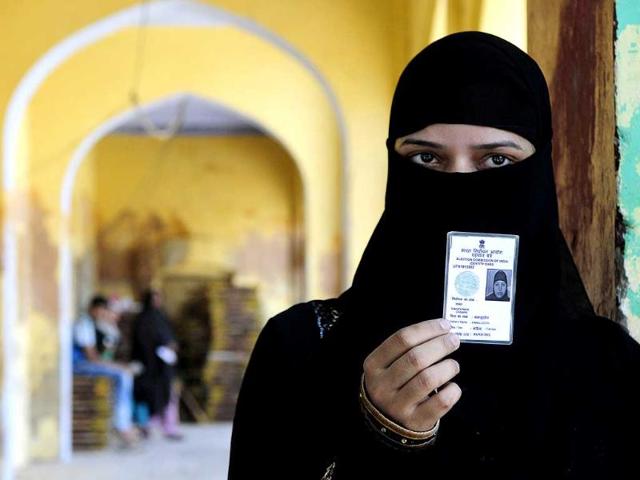 A muslim girl shows her voter ID card before cast her at the poling area of old city in Lucknow. (Deepak Gupta/HT Photo)