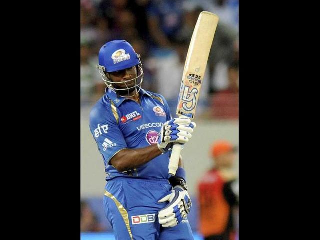 Kieron Pollard of Mumbai Indians raises his bat after scoring a half century during their IPL 7 match against Sunrisers Hyderabad in Dubai. (PTI Photo)