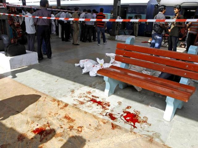 Blood lies splattered at a railway platform close to a passenger train that was ripped by two blasts at Chennai railway station. (AP photo)