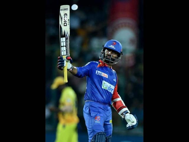 Dinesh Karthik of Delhi Daredevils raises his bat after completing his fifty during their IPL 7 match against Chennai Super Kings at Ferozshah Kotla in New Delhi. (PTI Photo)
