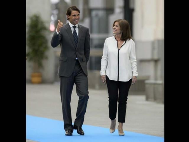Spanish-tennis-star-Rafael-Nadal-L-walks-with-Madrid-s-mayor-Ana-Botella-prior-to-being-named-adopted-son-of-the-Spanish-capital-at-the-City-Hall--AFP-Photo