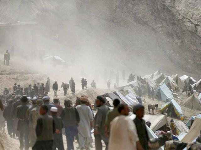 Afghan displaced villagers gather near the site of a landslide at the Argo district in Badakhshan province. (Reuters)