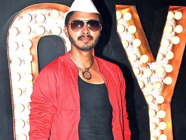 Shreyas Talpade, wearing an odd combination of a western outfit with a Gandhi cap, was at a shoot in Goregaon.