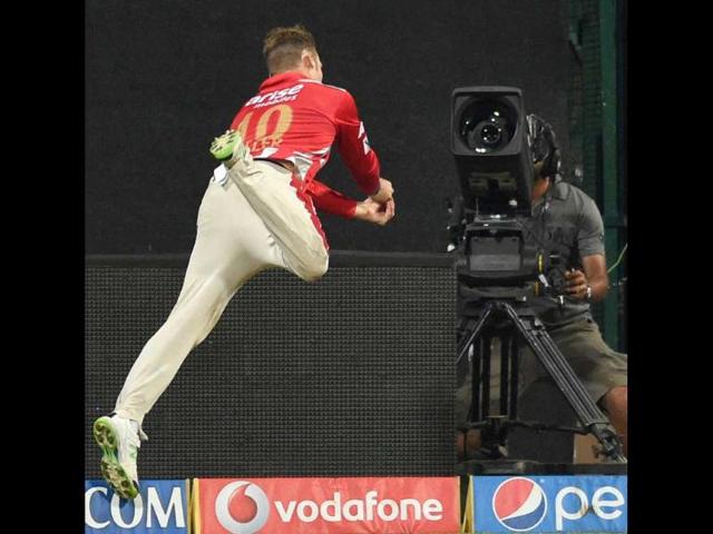 King’s XI Punjab’s David Miller leaps in the air to stop a six during their IPL 7 match against Royal Challengers Bangalore at Chinnaswamy Stadium in Bangalore. (PTI Photo)