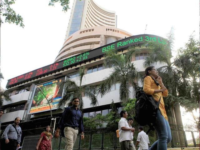 People-walk-past-a-billboard-outside-Bombay-Stock-Exchange-HT-Photo-Anshuman-Poyrekar