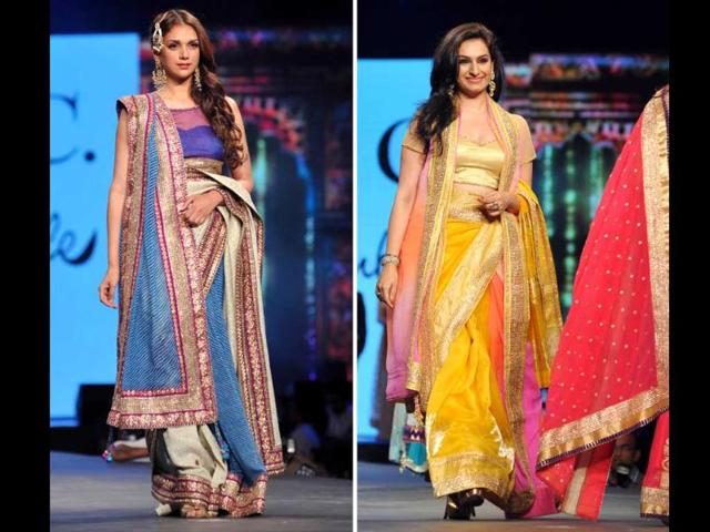 Actor Aditi Rao Hydari and playback singer Akriti Kakkar display a creation by designer Shaina NC during the fashion show. (AFP)