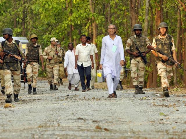 Election Commission officials carry the EVMs, guarded by the BSF and ITBF, in the Maoist affected Pardi villege, Baghmundi in Purulia district, West Bengal after polling. (HT photo/Samir Jana)