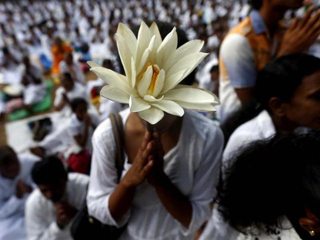 A Buddhist devotee worships at Kelaniya temple in Colombo on Vesak. (Reuters)