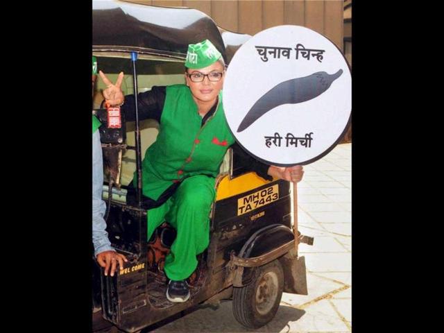 Actor Rakhi Sawant and Rashtriya Aam Party candidate found a quirky election symbol for her party - green chilli. Don't miss her matching attire! (PTI Photo)