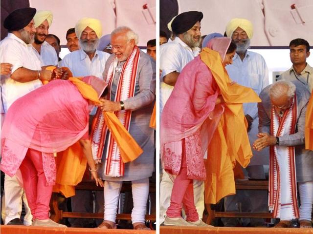 Shiromani Akali Dal candidate Harsimrat Kaur Badal touches the feet of Narendra Modi (L) and Modi gestures after Badal touched his feet (R) during an election rally in Bathinda. (PTI Photo)