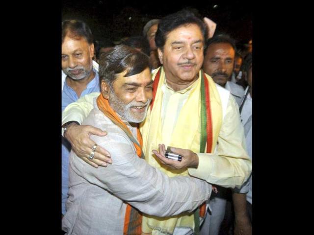 Ramkripal Yadav hugs Shatrughan Sinha as they celebrate BJP's victory in Lok Sabha elections in Patna. (PTI Photo)