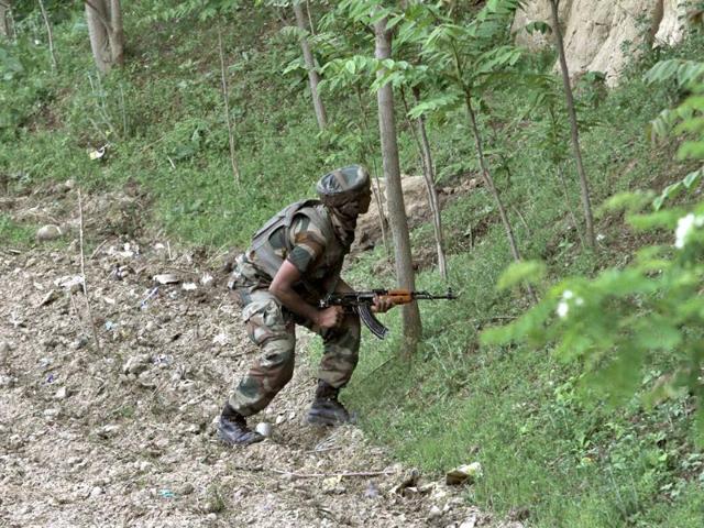 A soldier near the site of gun-battle at Chadoora town, about 25 kilometers south of Srinagar. (AP Photo)