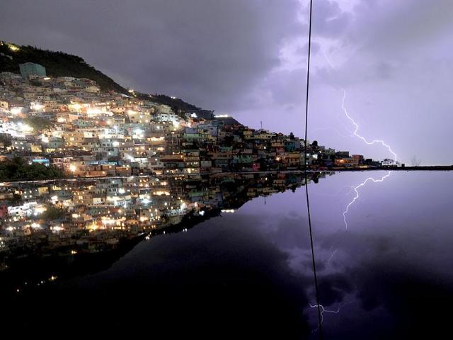 A long exposure shows lightning in the sky with reflection in the water on the floor of a building under construction during an evening thunderstorm in the Haitian capital Port-au-Prince. (AFP photo)