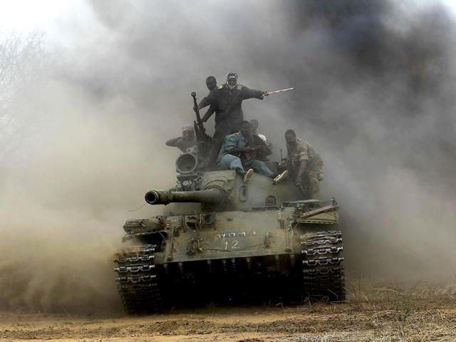 Sudanese Armed Forces (SAF) and Rapid Support Forces (RSF) personnel ride on a tank after recapturing the Daldako area, outside the military headquarters in Kadogli. (Reuters)