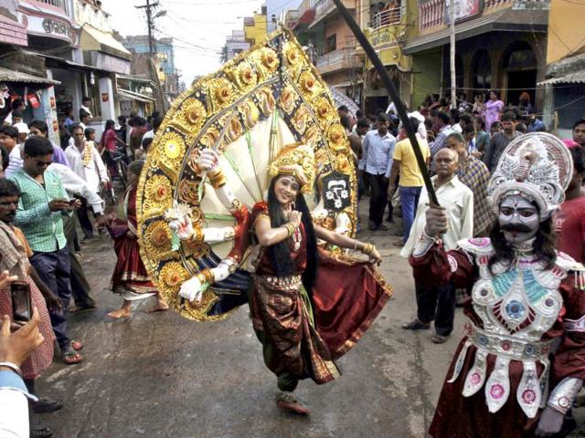 An artist dressed as goddess Durga performs during a procession on the occasion of Chandan Yatra festival in Puri, Bhubaneswar. (AP Photo)