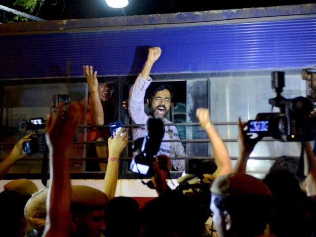 Aam Aadmi Party leader Yogendra Yadav shouts as he taken in police bus during a protest outside Tihar Prisons over the arrest of party chief Arvind Kejriwal in New Delhi. (PTI Photo)