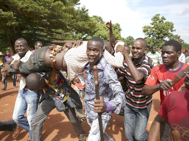 People carry a man who was shot by French soldiers after they opened fire at protesters blocking a road in Bambari. (Reuters Photo) People carry a man who was shot by French soldiers after they opened fire at protesters blocking a road in Bambari. (Reuters Photo)