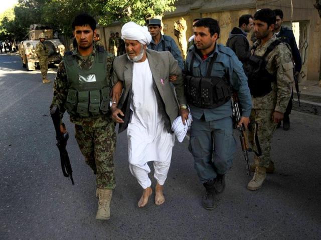 Afghan security forces escort a man away from the scene of an attack on the Indian consulate in Herat. (AFP photo)