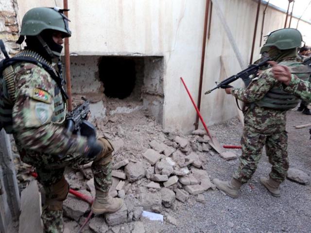 Afghan soldiers take position outside the building of the Indian consulate, during a gun battle with the Taliban attackers in Herat. (EPA photo)