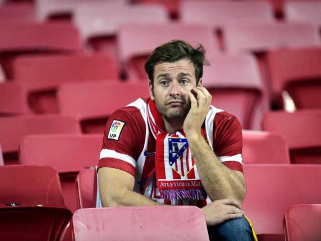 An Atletico Madrid fan reacts at the end of the UEFA Champions League final against Real Madrid in Lisbon. (AFP Photo)