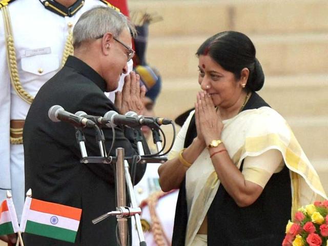 President Pranab Mukherjee greets newly sworn-in minister Sushma Swaraj after administering her the oath at a ceremony at Rashtrapati Bhavan in New Delhi . (PTI Photo)