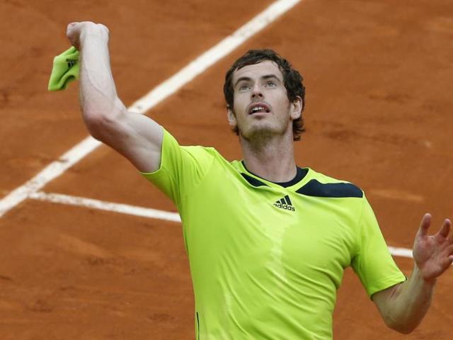 Britain's Andy Murray throws his sweat wristband to cheering fans after winning his second round match of the French Open against Australia's Marinko Matosevic at the Roland Garros stadium, in Paris. (AP Photo)