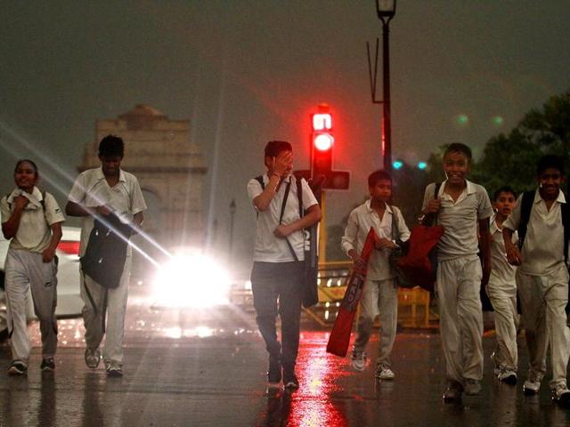 Students get caught in the sudden rain in the evening in New Delhi. (photo by Arun Sharma/ Hindustan Times)
