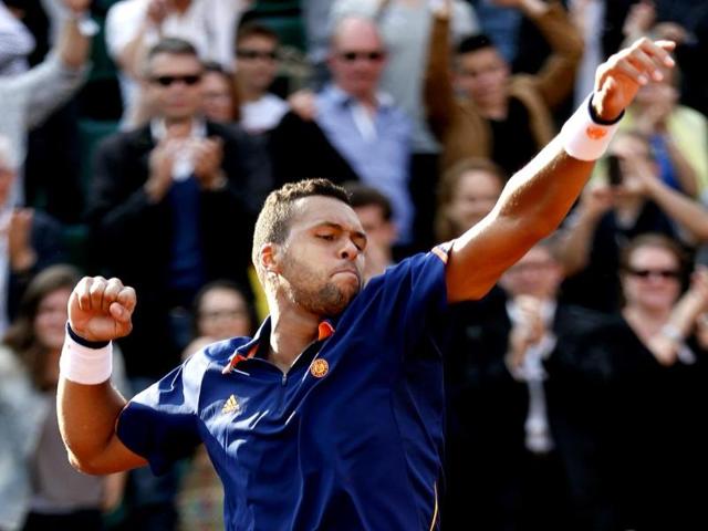 Jo-Wilfried Tsonga of France celebrates his victory over Jerzy Janowicz of Poland in their men's singles match at the French Open at Roland Garros in Paris. (Reuters Photo)