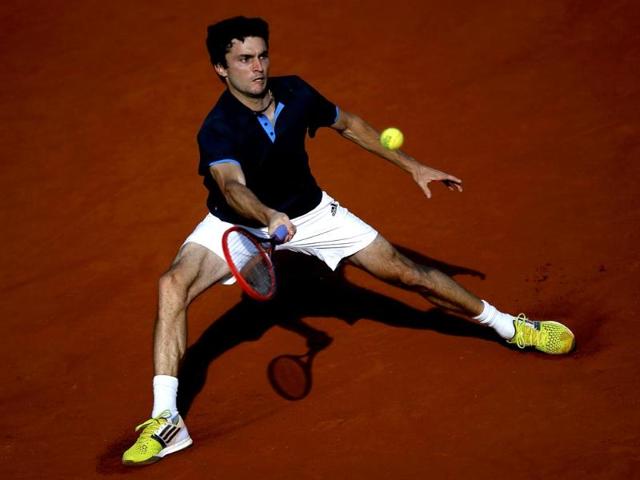 Gilles Simon of France returns a forehand to Milos Raonic of Canada during their men's singles match at the French Open at Roland Garros in Paris. (Reuters Photo)