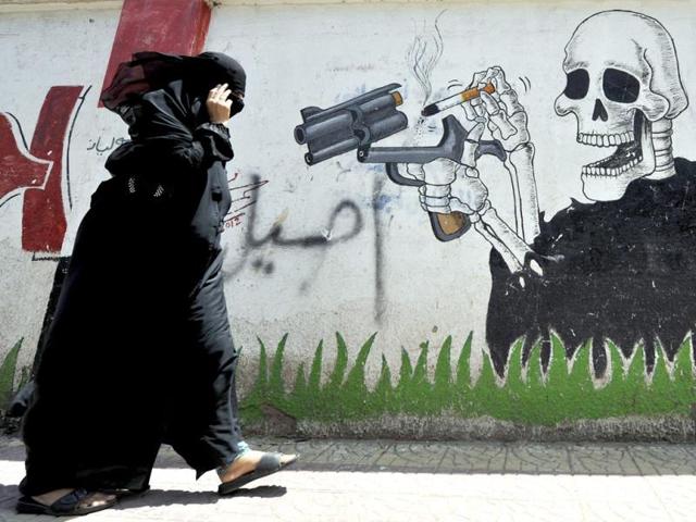 A Yemeni woman passes a wall sprayed with anti-smoking graffiti on 'World No Tobacco Day' in Sana’a, Yemen. (EPA Photo) A Yemeni woman passes a wall sprayed with anti-smoking graffiti on 'World No Tobacco Day' in Sana’a, Yemen. (EPA Photo)