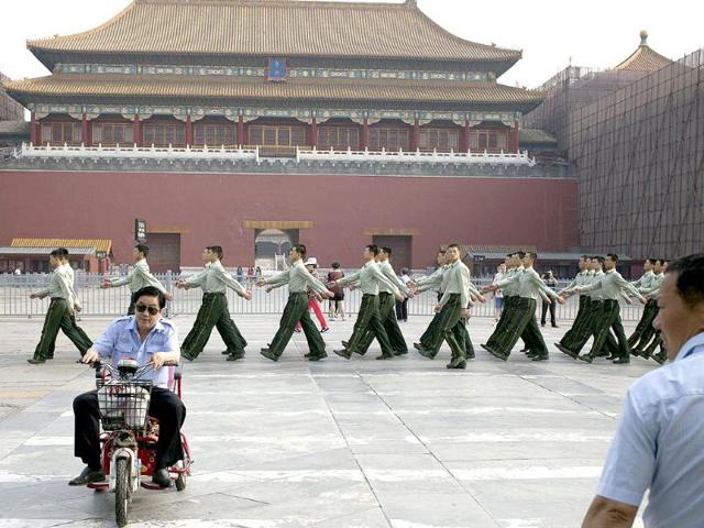 Chinese paramilitary policemen march in front of the entrance to the Forbidden City near Tiananmen Square in Beijing. Authorities in Beijing blanketed the city center with heavy security on the 25th anniversary of the bloody military suppression of pro-democracy protests centered on Tiananmen Square. (AP Photo)