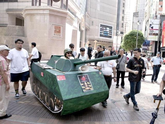 Activists walk with a replica of a Chinese tank in Hong Kong to commemorate the 1989 Tiananmen Square military crackdown in Beijing on pro-democracy protesters. Up to 200,000 people were set to take part in a candlelight vigil in Hong Kong on June 4 to commemorate the 25th anniversary of the bloody Tiananmen Square crackdown, as China seeks to wipe the incident from memory. (AFP photo)