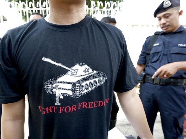 A protester wears a T-shirt with a tank during a protest in front of the Chinese Embassy in Kuala Lumpur, Malaysia. The protest was held to commemorate the 25th anniversary of the Tiananmen Square tragedy where China's military cracked down on pro-democracy protesters in 1989. (AP Photo)