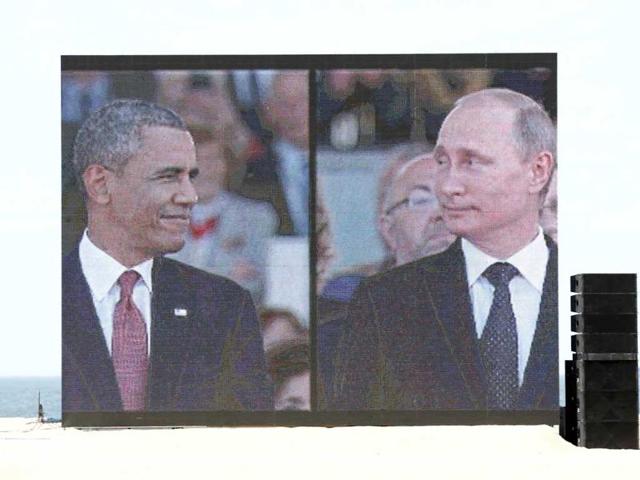A huge video screen on Sword Beach shows US President Barack Obama and Russian President Vladimir Putin as they arrive for the International 70th D-Day Commemoration Ceremony in Ouistreham. World leaders and veterans gathered by the beaches of Normandy on Friday to mark the 70th anniversary of the Allied D-Day landings that helped turn the tables in World War Two. (Reuters)