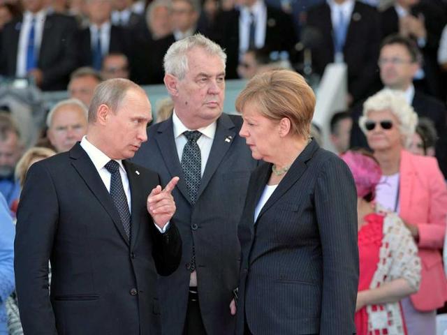 Russian President Vladimir Putin (left) chats with German Chancellor Angela Merkel (right) and Czech President Milos Zeman (centre) during the 70th anniversary of the D-Day landings, on Sword beach, Ouistreham, Normandy. More than 130,000 allied Troops landed on the beaches of Normandy on 06 June 1944. The invasion established a crucial second front in the Liberation of Europe from Nazi occupation, ultimately leading to victory for Allied Forces in 1945. EPA