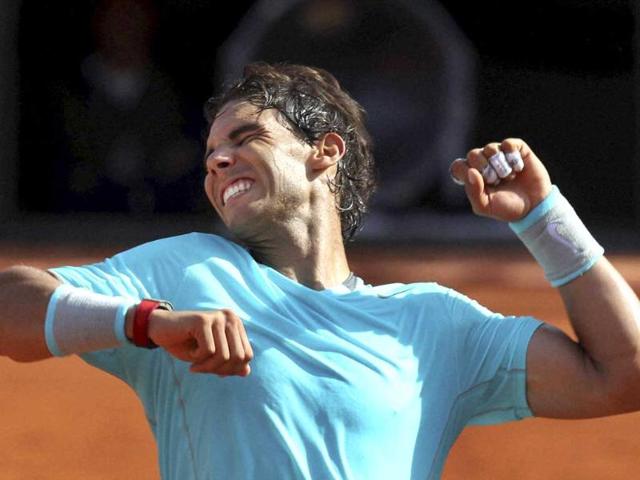 Spain's Rafael Nadal celebrates winning the semi-final match of the French Open against Britain's Andy Murray at Roland Garros in Paris. (AP Photo)