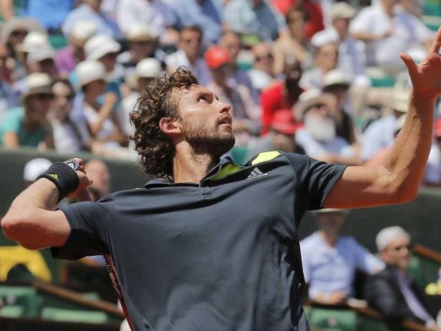 Latvia's Ernests Gulbis serves the ball during the semi-final match of the French Open against Serbia's Novak Djokovic at Roland Garros, in Paris. (AP Photo)