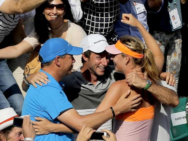 Russia's Maria Sharapova hugs her coaches after defeating Romania's Simona Halep during their final match of the French Open at Roland Garros in Paris. (AP Photo)