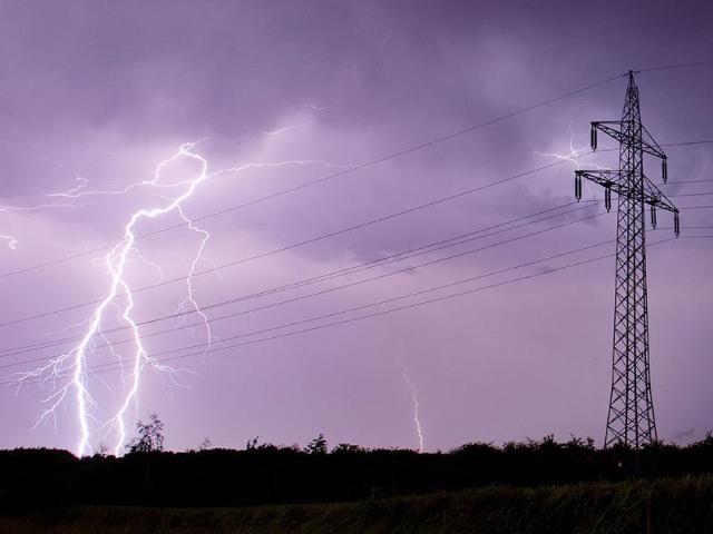 Lightning bolts illuminate the sky as they strike near high voltage power lines in Sehnde, near Hanover, northern Germany. Thunderstorms with heavy rains and hail are passing over parts of Germany. (EPA)