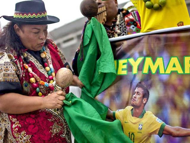 A shaman holds a poster of Brazil's Neymar. (AFP Photo)